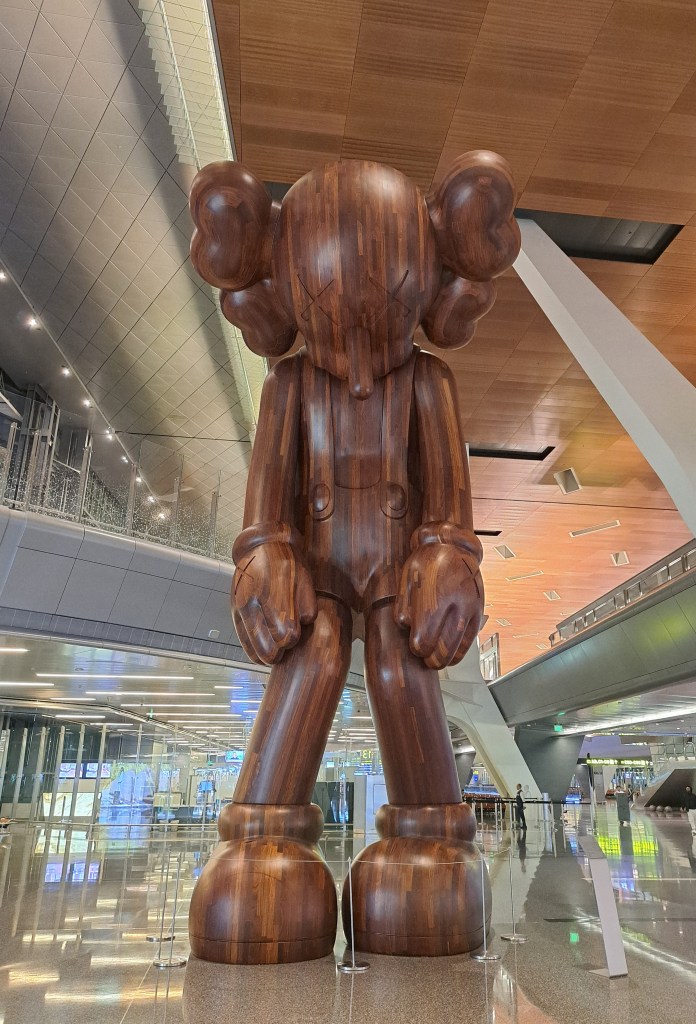 Large wooden teddy bear sculpture at the Hamad International Airport